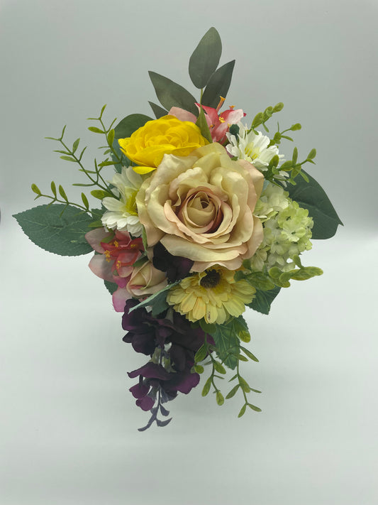 Custom bouquet designed to fit a small wall niche memorial. Flowers and foliage hand set to frame the space. Set in a foam base. Measures approximately 6" x 6" x 8" 