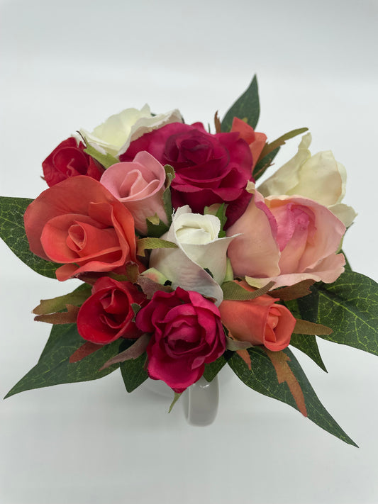 A mini bouquet of roses set in an antique vessel.   Measures approximately 5" x 5" x 5" (vase included)