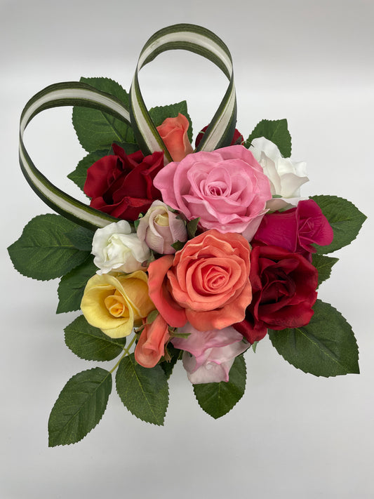 Custom bouquet of roses in honor of grandmother and her beautiful rose garden. Each rose representing her children. Includes several real touch flowers. Measures approximately 10" x 10" x 10"